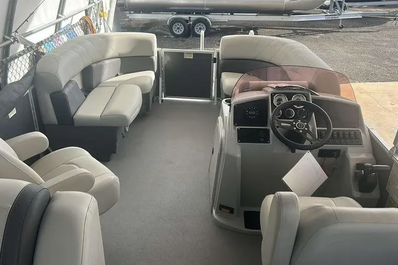Slide: The Image of 2023 Sylvan Mirage 820 LZ pontoon boat interior with plush seating and modern helm. - 7