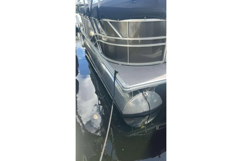 Slide: The Image of 2023 Sylvan Mirage 820 LZ pontoon boat docked on calm water. - 9