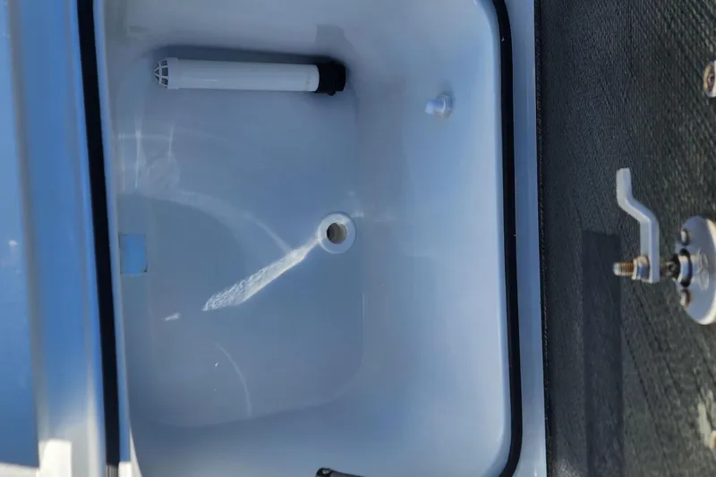 Slide: The Image of 2022 East Cape Vantage VHP boat compartment with drain and handle. - 11