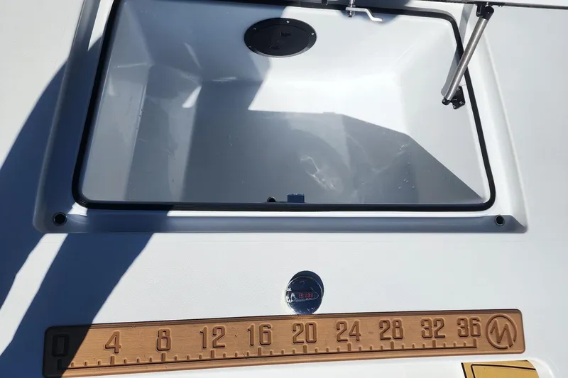 Slide: The Image of 2022 East Cape Vantage VHP boat hatch with measuring ruler on deck. - 3