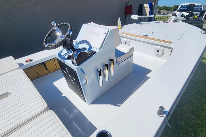 Slide: The Image of 2022 East Cape Vantage VHP boat interior with steering console and seating. - 4