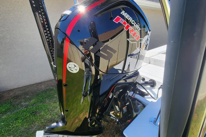 Slide: The Image of 2022 East Cape Vantage VHP with Mercury Pro XS outboard motor, parked outdoors. - 6