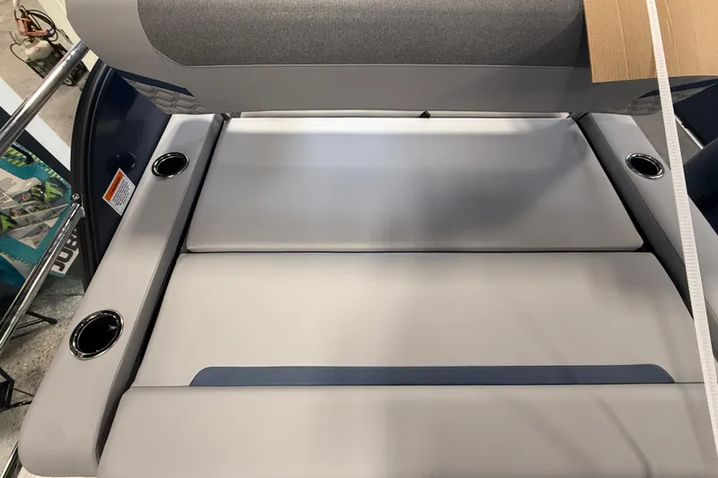 Slide: The Image of 2026 Crest Conquest 230 SLSC boat interior with cushioned seating and cup holders. - 10