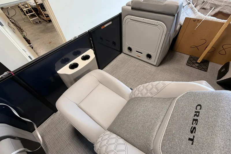 Slide: The Image of 2026 Crest Conquest 230 SLSC interior with plush seating and cup holders. - 14