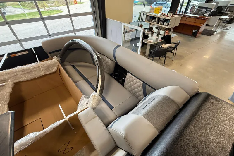 Slide: The Image of 2026 Crest Conquest 230 SLSC pontoon boat interior in showroom setting. - 15
