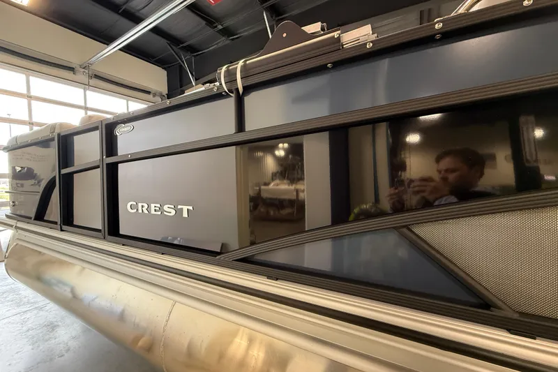 Slide: The Image of 2026 Crest Conquest 230 SLSC pontoon boat in a showroom setting. - 8