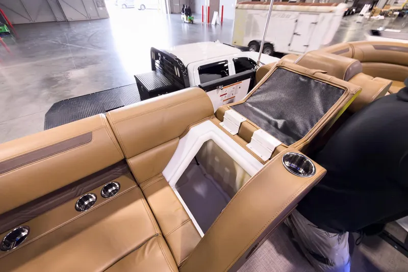 Slide: The Image of 2026 Montara Surf Boss EVO SL 23' interior with tan leather seats and built-in storage. - 26