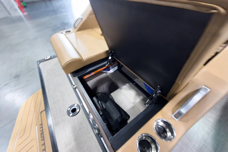 Slide: The Image of Open storage compartment in 2026 Montara Surf Boss EVO SL 23' boat with tan seating. - 28