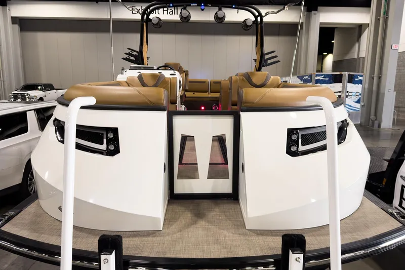 Slide: The Image of 2026 Montara Surf Boss EVO SL 23' boat interior with tan seating, showcased in an exhibit hall. - 6