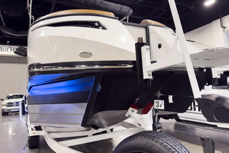 Slide: The Image of 2026 Montara Surf Boss EVO SL 23' boat on display with sleek design and blue lighting. - 8
