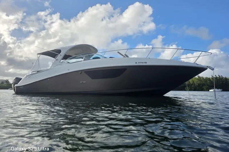 The Image of 2010 Sea Ray 370 Sundancer yacht on calm water under a partly cloudy sky. - 0