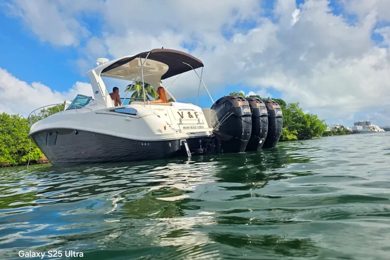 Slide: The Image of 2010 Sea Ray 370 Sundancer boat on water, featuring multiple outboard engines. - 11