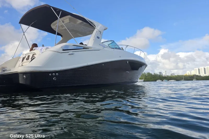 Slide: The Image of 2010 Sea Ray 370 Sundancer yacht on calm water under blue sky. - 12