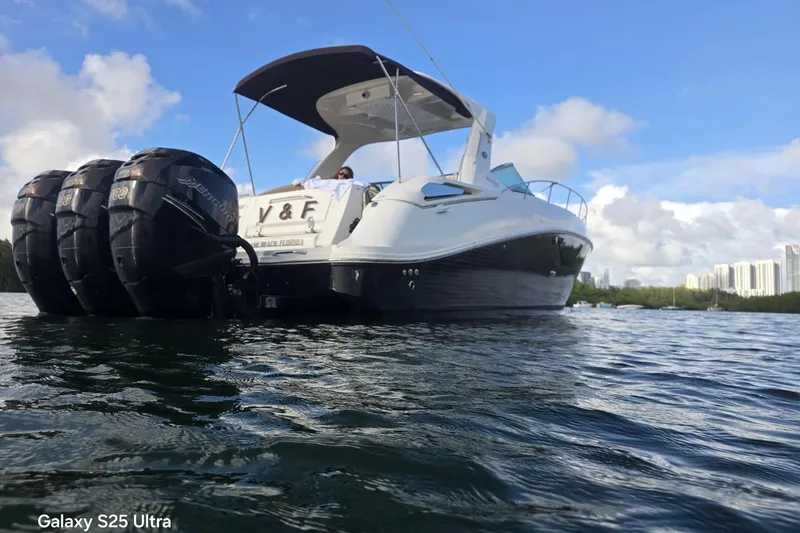 Slide: The Image of 2010 Sea Ray 370 Sundancer yacht on water, featuring triple outboard engines. - 15