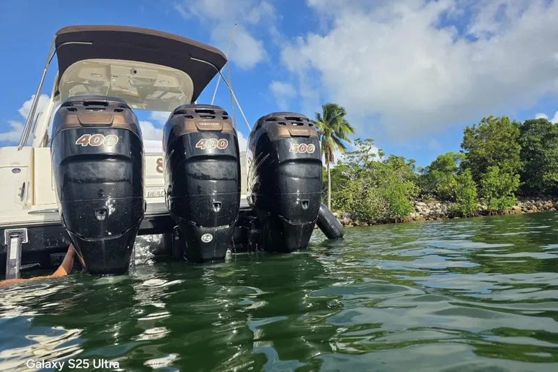 Slide: The Image of 2010 Sea Ray 370 Sundancer with triple 400 horsepower outboard engines on a sunny day. - 16