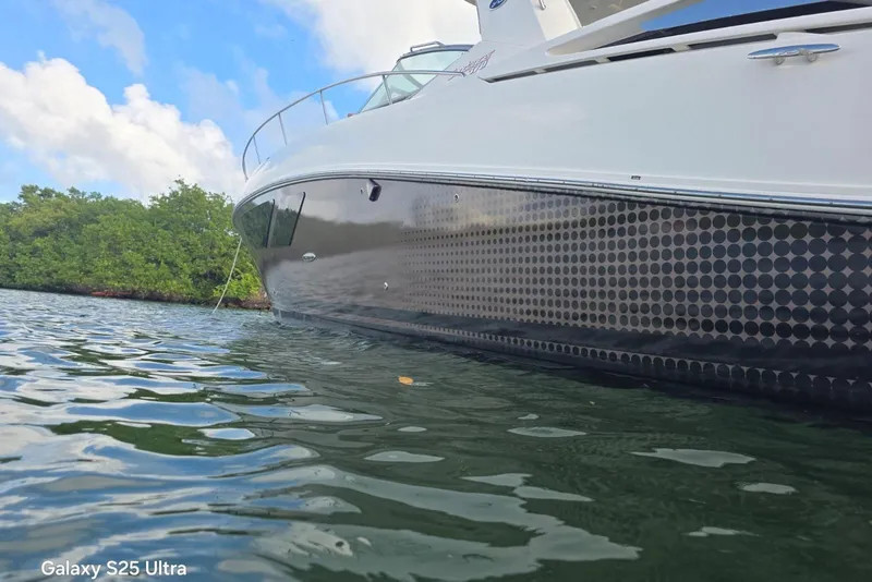 Slide: The Image of 2010 Sea Ray 370 Sundancer yacht on calm water, showcasing sleek design. - 18