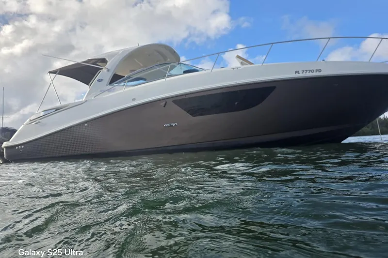 Slide: The Image of 2010 Sea Ray 370 Sundancer yacht on water under cloudy sky. - 19