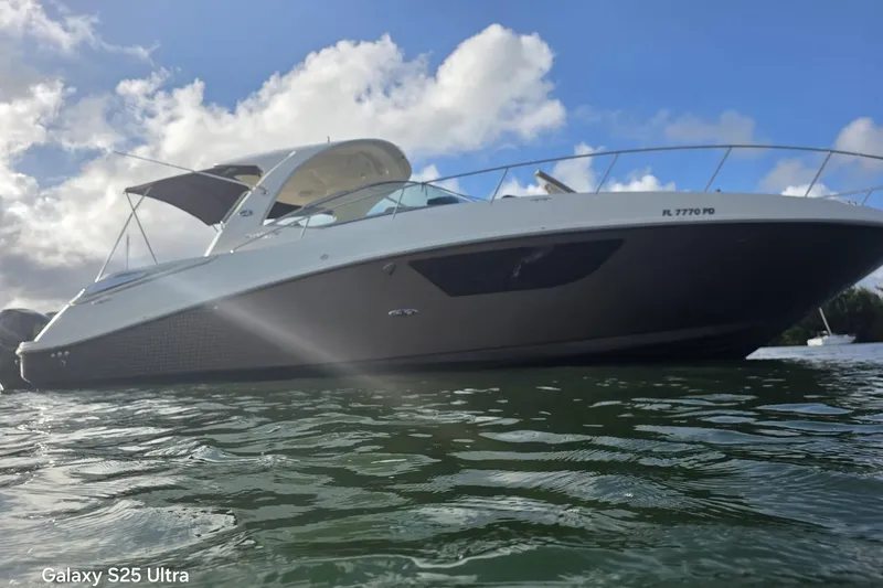 Slide: The Image of 2010 Sea Ray 370 Sundancer yacht on water under cloudy sky. - 2