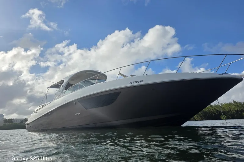 Slide: The Image of 2010 Sea Ray 370 Sundancer yacht on water under blue sky. - 5