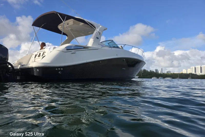 Slide: The Image of 2010 Sea Ray 370 Sundancer boat on water under clear blue sky. - 6
