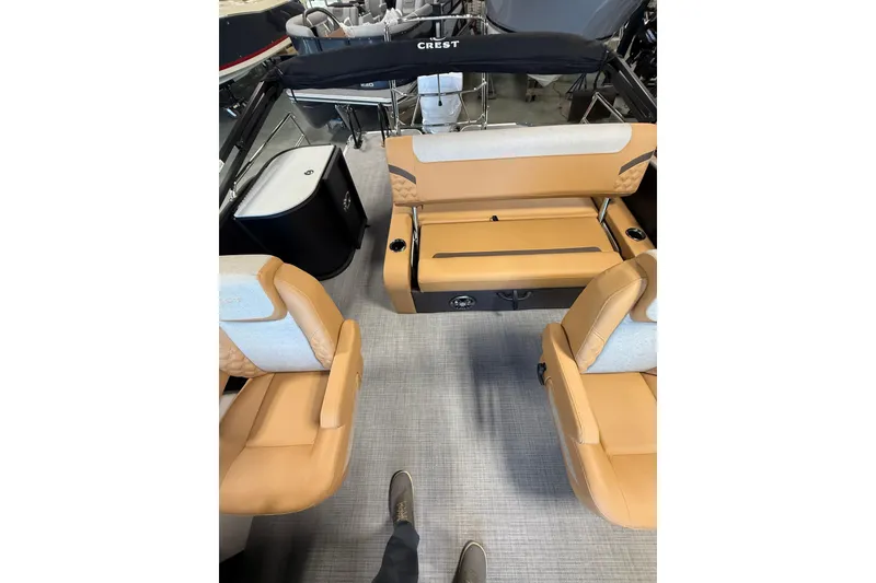 Slide: The Image of 2026 Crest Conquest 230 SLSC boat interior with tan seating and modern design. - 10