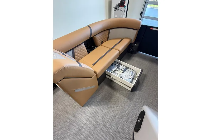 Slide: The Image of Luxurious seating with storage on 2026 Crest Conquest 230 SLSC boat interior. - 11