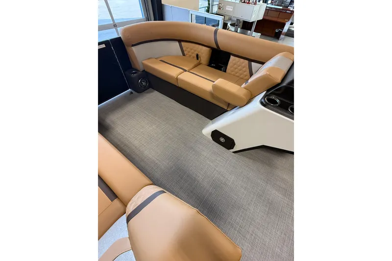 Slide: The Image of Luxurious interior of 2026 Crest Conquest 230 SLSC pontoon boat with tan seating. - 12