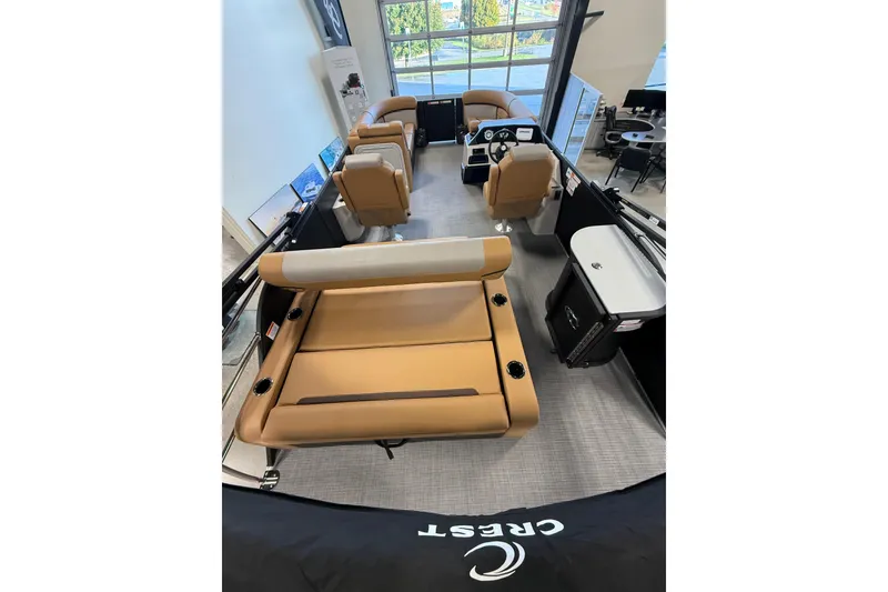 Slide: The Image of 2026 Crest Conquest 230 SLSC pontoon boat interior with tan seating and modern design. - 6