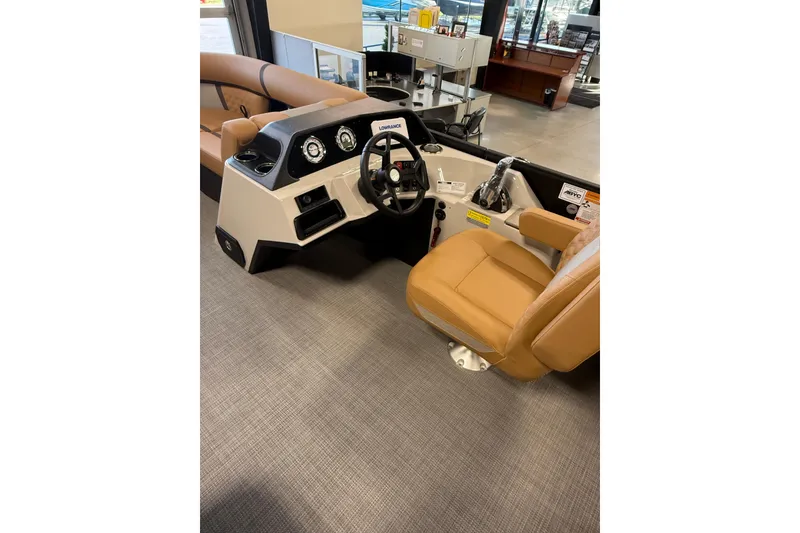 Slide: The Image of 2026 Crest Conquest 230 SLSC boat interior with tan seating and modern dashboard controls. - 8