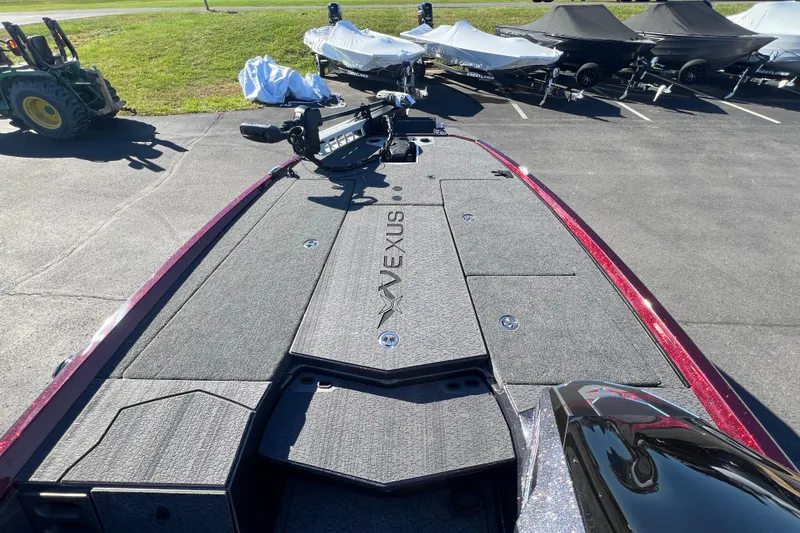 Slide: The Image of 2026 Vexus VXS20 boat deck with storage compartments and trolling motor, parked outdoors. - 7