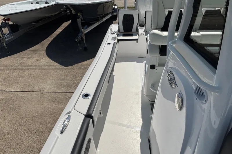 Slide: The Image of 2026 Tidewater 2700 Carolina Bay boat with ladder and trailer, rear view. - 10