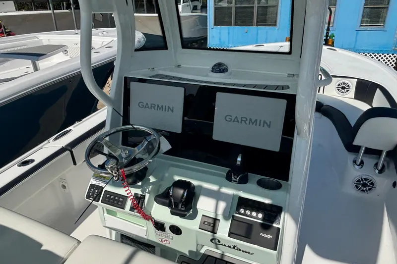 Slide: The Image of 2026 Tidewater 2700 Carolina Bay boat with rod holders and speakers on the T-top. - 12