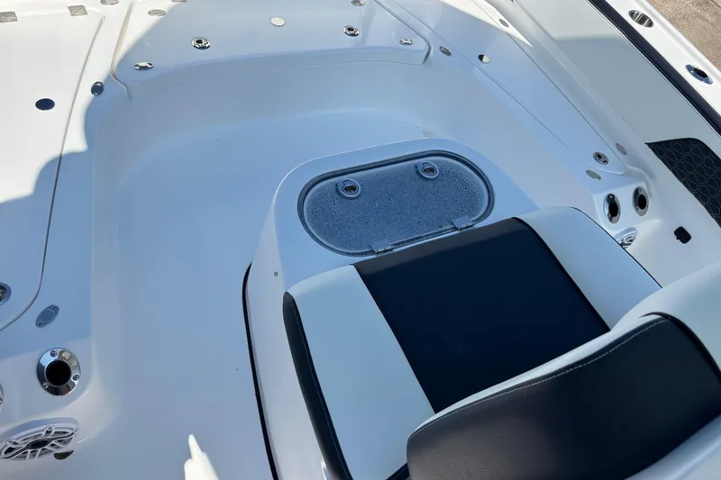 Slide: The Image of 2026 Tidewater 2700 Carolina Bay boat deck with storage compartments and speakers. - 15