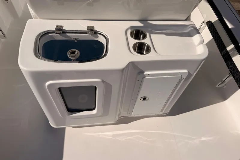 Slide: The Image of 2026 Tidewater 2700 Carolina Bay boat console with sink and cup holders. - 19
