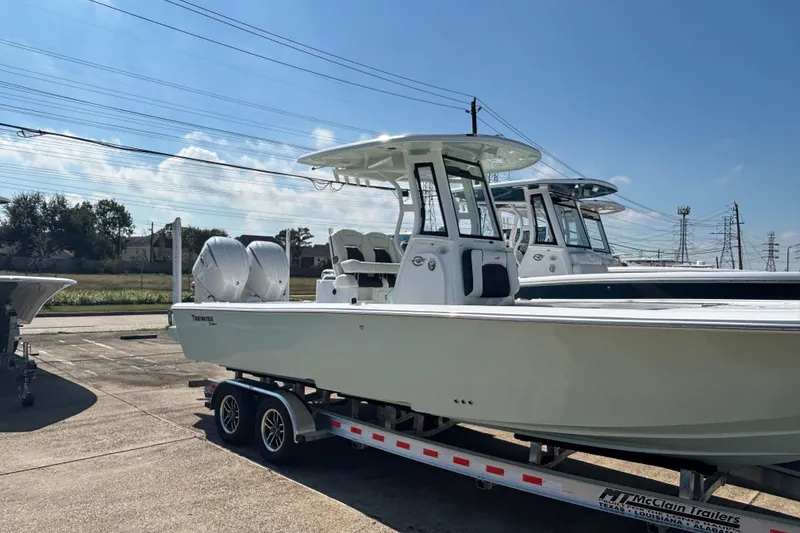 Slide: The Image of 2026 Tidewater 2700 Carolina Bay boat on trailer at dealership. - 2
