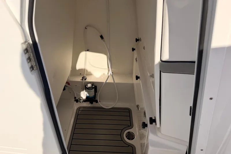 Slide: The Image of Interior of 2026 Tidewater 2700 Carolina Bay boat, featuring a compact shower area. - 30