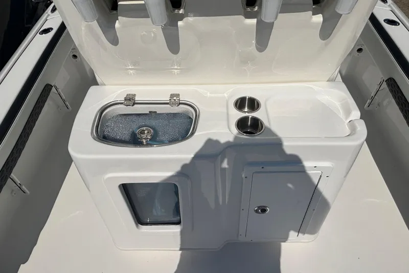 Slide: The Image of 2026 Tidewater 2700 Carolina Bay boat with dual outboard engines, displayed outdoors. - 7