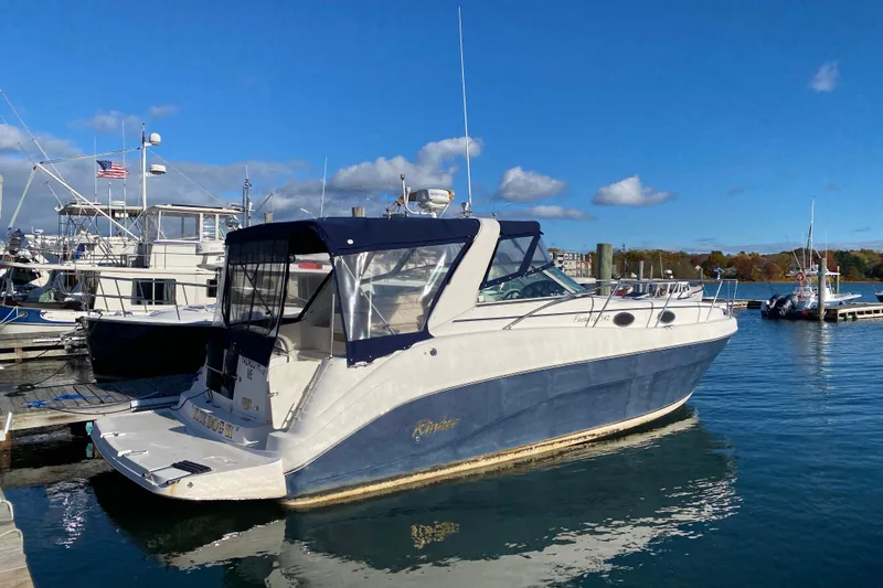 Slide: The Image of 2004 Rinker Fiesta Vee 342 boat docked at marina under clear blue sky. - 1