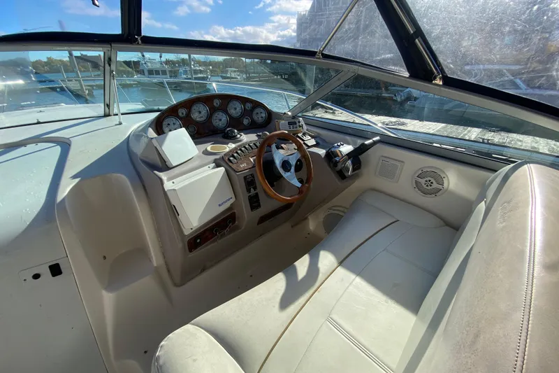 Slide: The Image of 2004 Rinker Fiesta Vee 342 boat cockpit with steering wheel and control panel. - 11