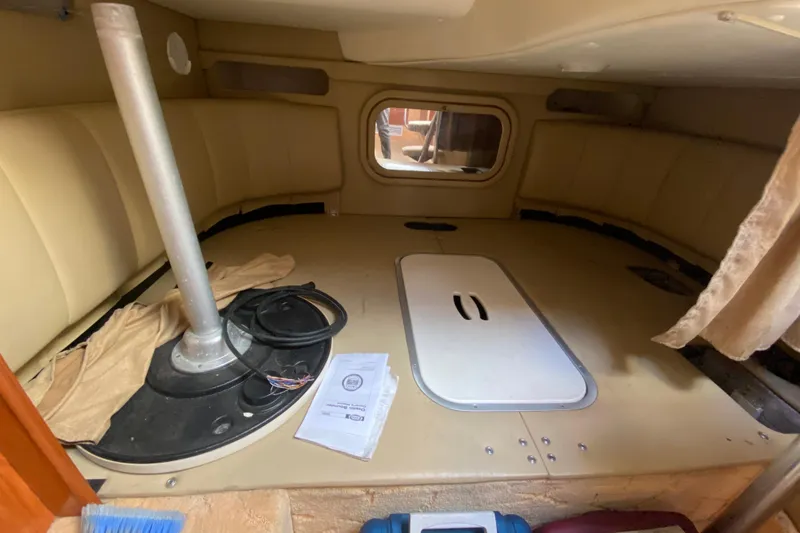 Slide: The Image of 2004 Rinker Fiesta Vee 342 cabin interior with seating and storage space. - 16