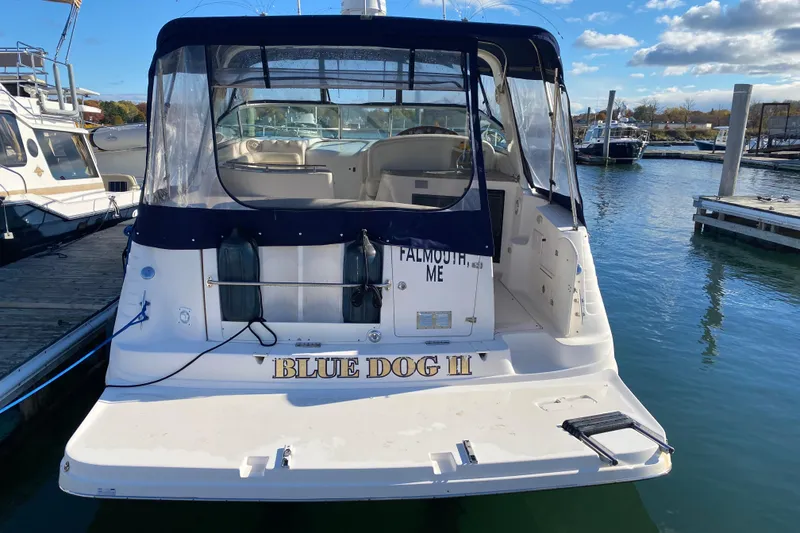 Slide: The Image of 2004 Rinker Fiesta Vee 342 boat docked, named "Blue Dog II," in a marina setting. - 2