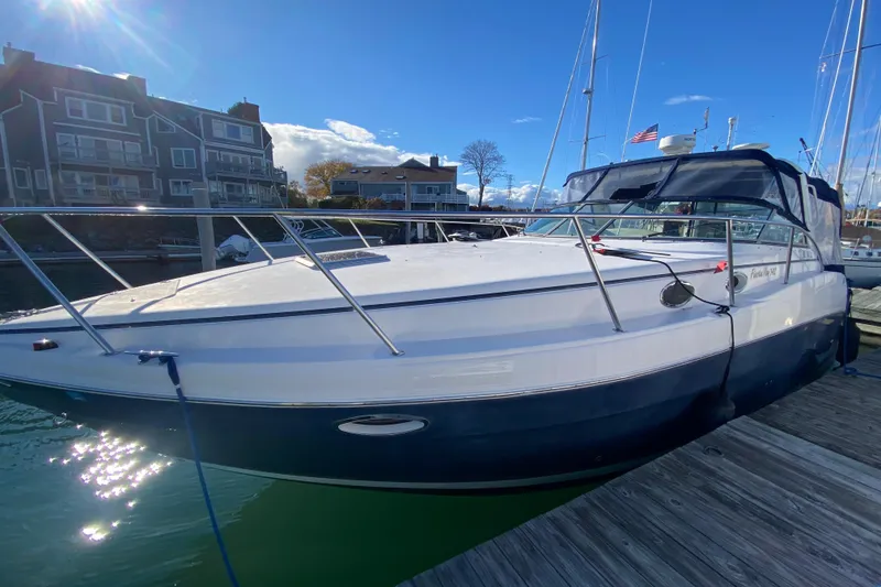 Slide: The Image of 2004 Rinker Fiesta Vee 342 boat docked at marina under clear blue sky. - 5