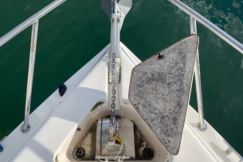 Slide: The Image of Bow of 2004 Rinker Fiesta Vee 342 with anchor and chain, surrounded by calm water. - 7