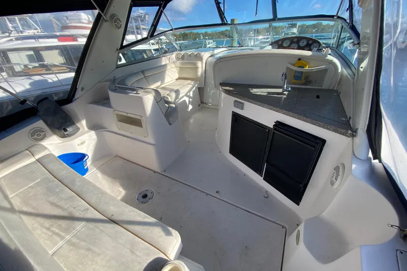 Slide: The Image of 2004 Rinker Fiesta Vee 342 boat interior with seating and kitchenette area. - 8