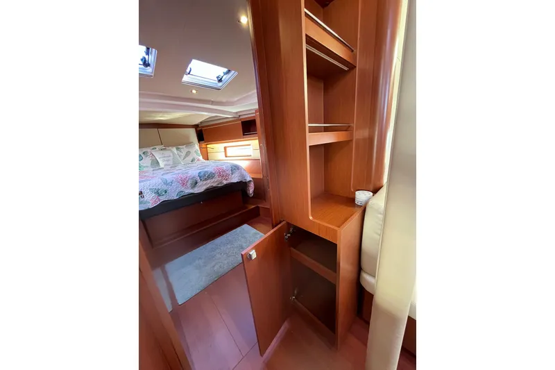 Slide: The Image of Interior of Beneteau Oceanis 46.1 yacht, bedroom with wooden cabinets, year 2020. - 41