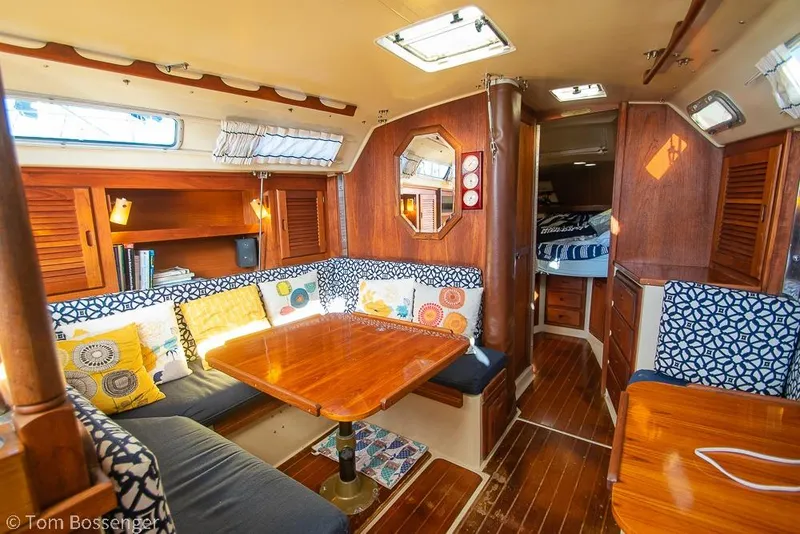 Slide: The Image of Interior of 1985 Catalina 36 sailboat with cozy seating and wooden finishes. - 11