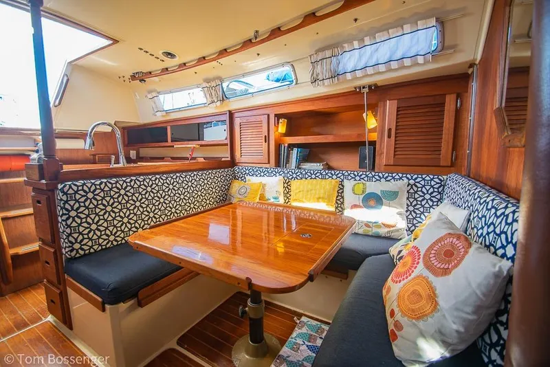 Slide: The Image of Interior of a 1985 Catalina 36 sailboat with cozy seating and wooden table. - 15