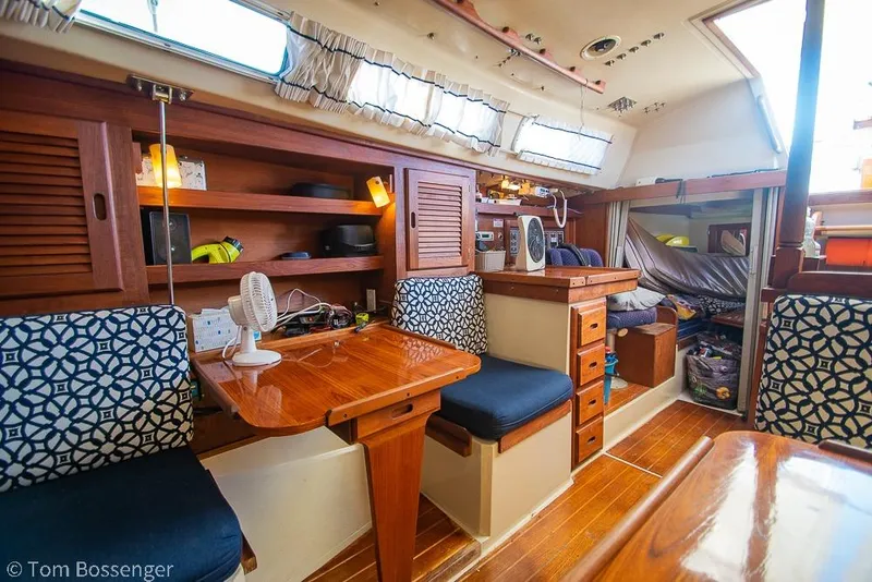 Slide: The Image of Interior of a 1985 Catalina 36 sailboat with wooden furnishings and patterned cushions. - 16
