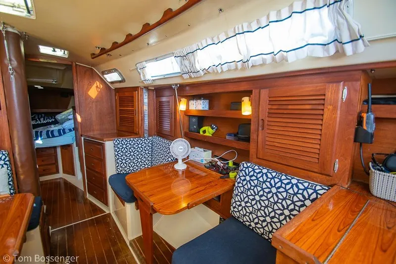 Slide: The Image of Interior of a 1985 Catalina 36 sailboat with wooden furnishings and cozy seating area. - 17