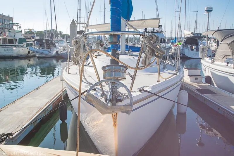 Slide: The Image of 1985 Catalina 36 sailboat docked in a marina, surrounded by other boats. - 2